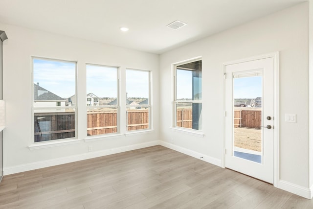 unfurnished sunroom with a wealth of natural light