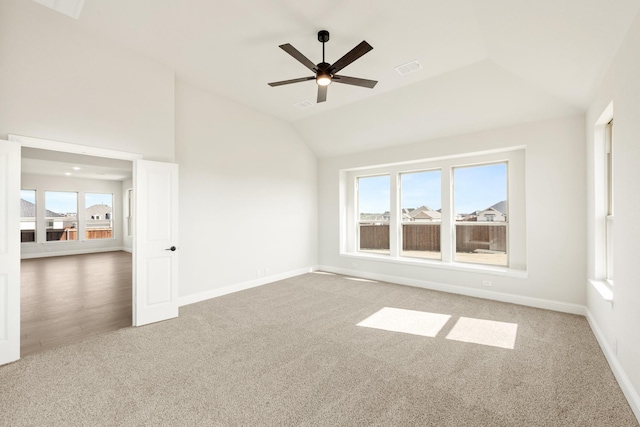 spare room featuring vaulted ceiling, ceiling fan, and carpet floors