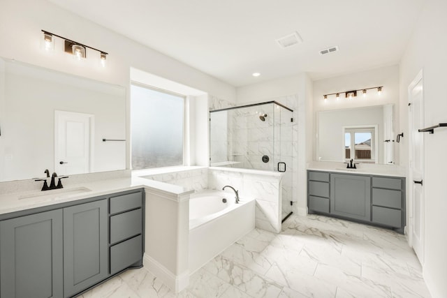 bathroom with vanity and independent shower and bath