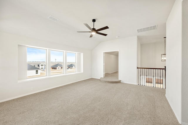 empty room featuring carpet floors, lofted ceiling, and ceiling fan