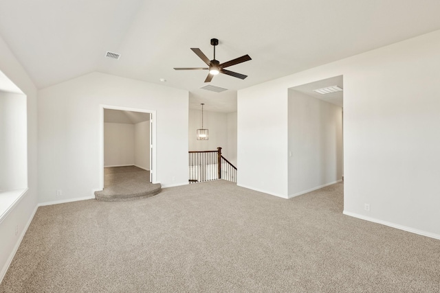 carpeted empty room featuring ceiling fan and vaulted ceiling