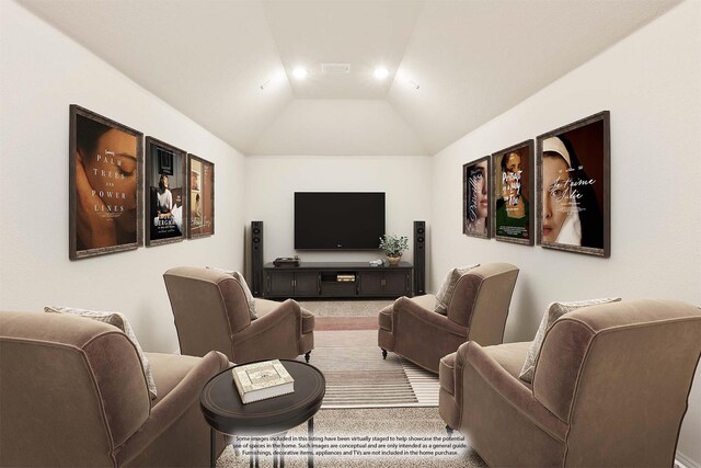 carpeted living room with ceiling fan and vaulted ceiling