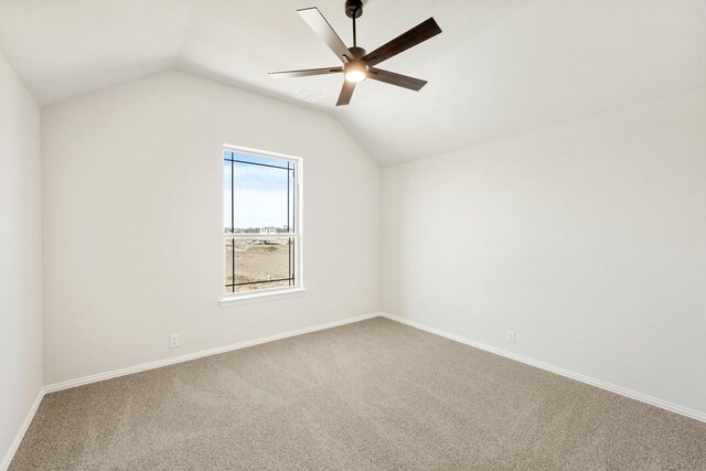 carpeted living room featuring ceiling fan and vaulted ceiling