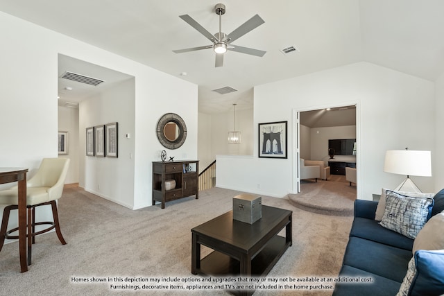 carpeted living room with ceiling fan and vaulted ceiling