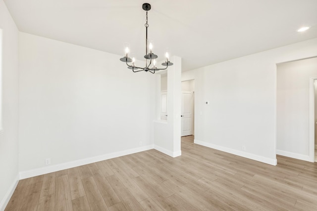 unfurnished dining area with light wood-type flooring and a chandelier