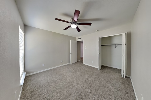 unfurnished bedroom featuring carpet floors, a ceiling fan, baseboards, and a closet