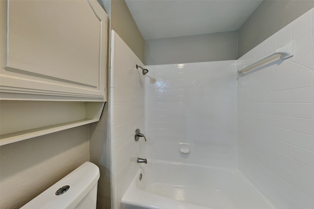 bathroom featuring shower / tub combination and toilet