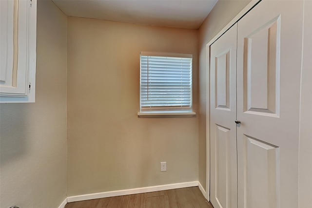 empty room featuring baseboards and wood finished floors