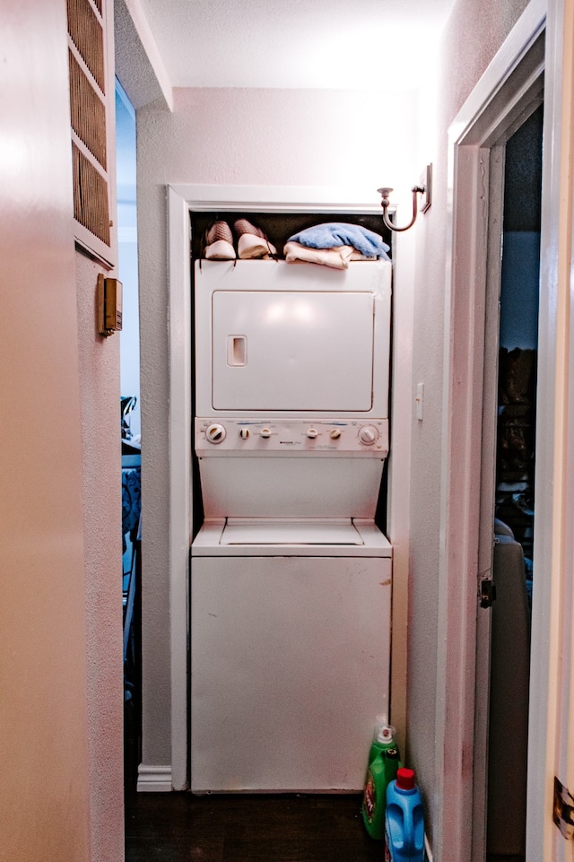 laundry room with stacked washer / dryer