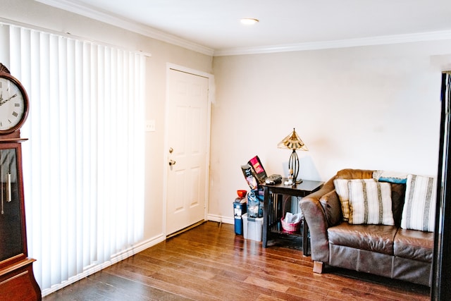 living area with hardwood / wood-style floors and crown molding