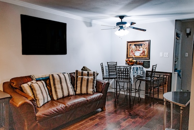 living room with crown molding, dark wood-type flooring, and ceiling fan