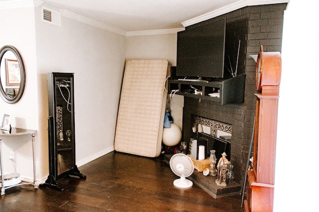 living room featuring dark wood-type flooring, ornamental molding, and a fireplace