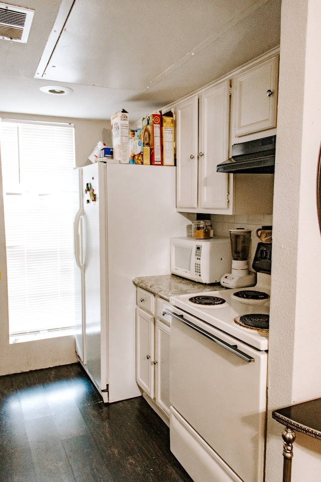 kitchen with dark hardwood / wood-style floors, white appliances, and white cabinetry