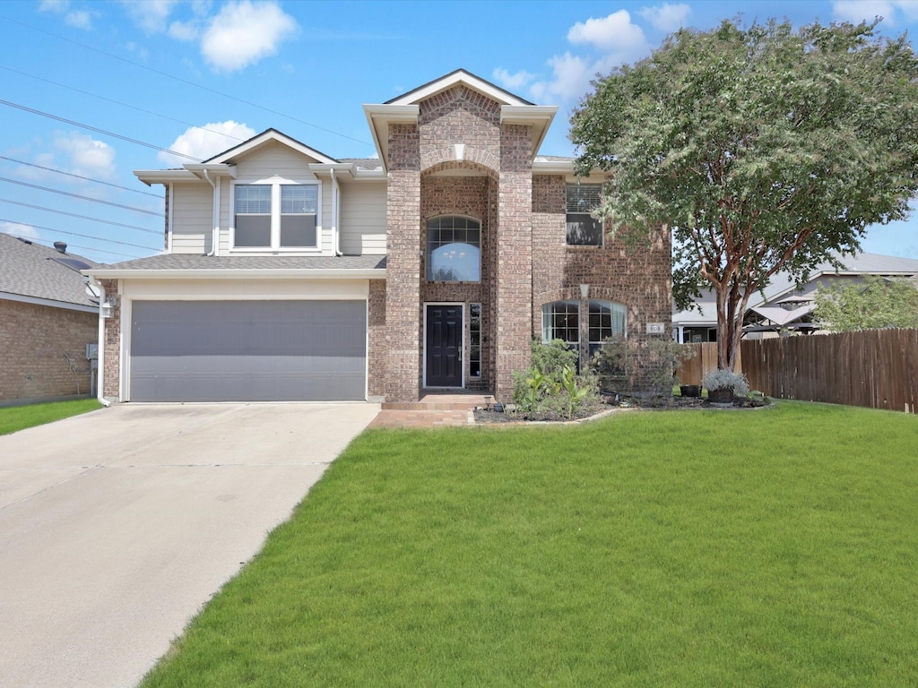 view of front of house featuring a front lawn and a garage