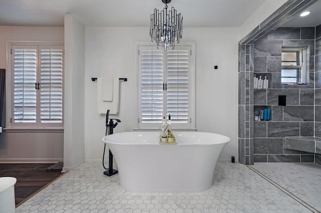 bathroom featuring a wealth of natural light, plus walk in shower, and tile patterned floors