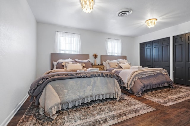 bedroom with dark hardwood / wood-style floors