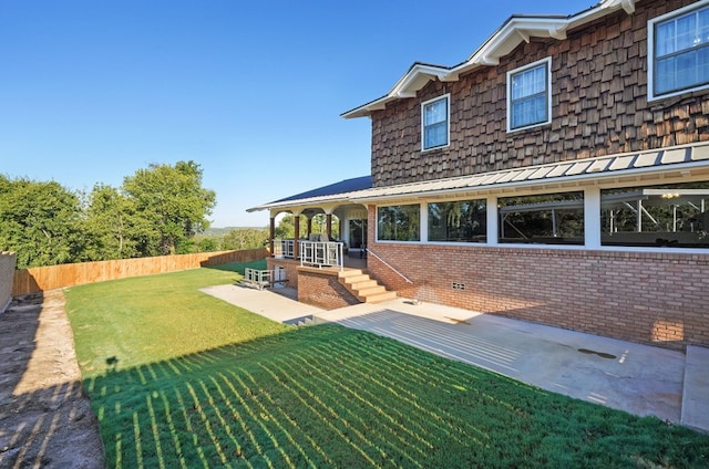 rear view of house featuring a lawn