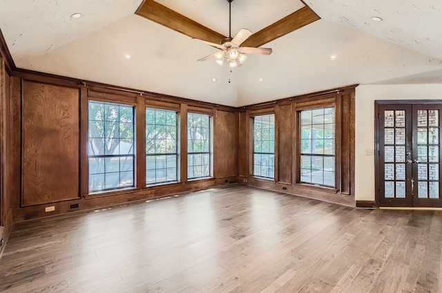 unfurnished room with french doors, vaulted ceiling with beams, ceiling fan, and wood-type flooring