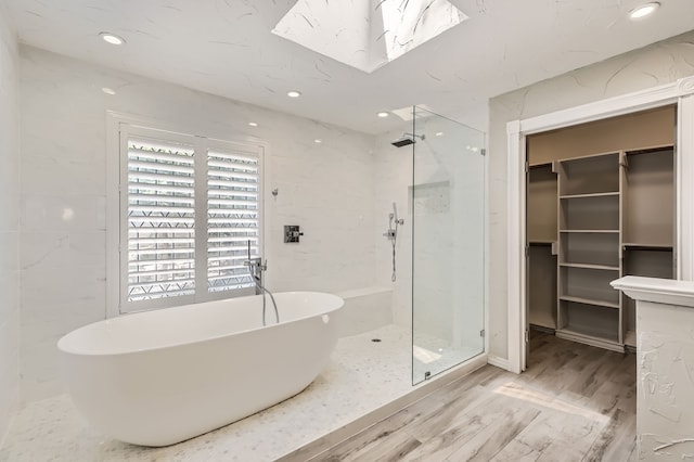 bathroom with plus walk in shower and hardwood / wood-style flooring