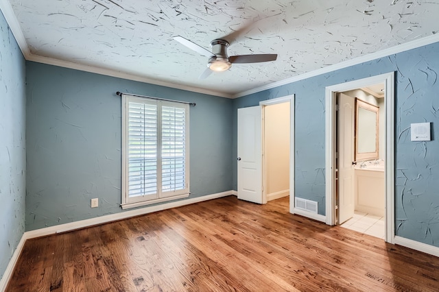 unfurnished bedroom with ceiling fan, ensuite bathroom, light hardwood / wood-style floors, and ornamental molding