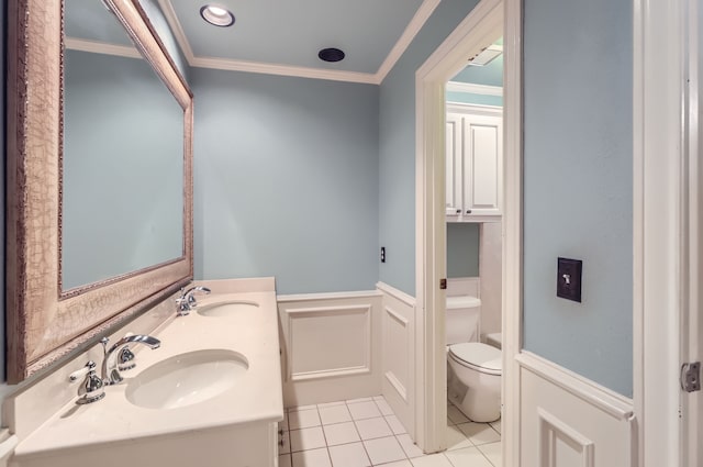 bathroom featuring tile patterned floors, toilet, crown molding, and sink