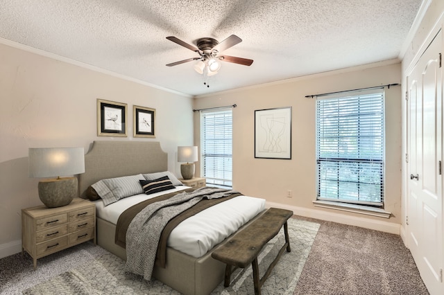 carpeted bedroom with a textured ceiling, multiple windows, and ceiling fan