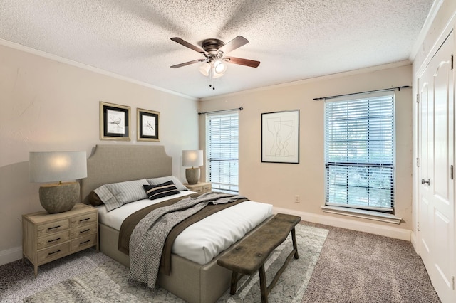 carpeted bedroom with multiple windows, crown molding, ceiling fan, and a textured ceiling