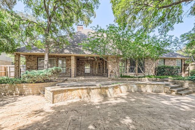 back of property featuring ceiling fan