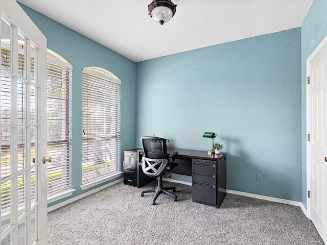 carpeted office featuring baseboards