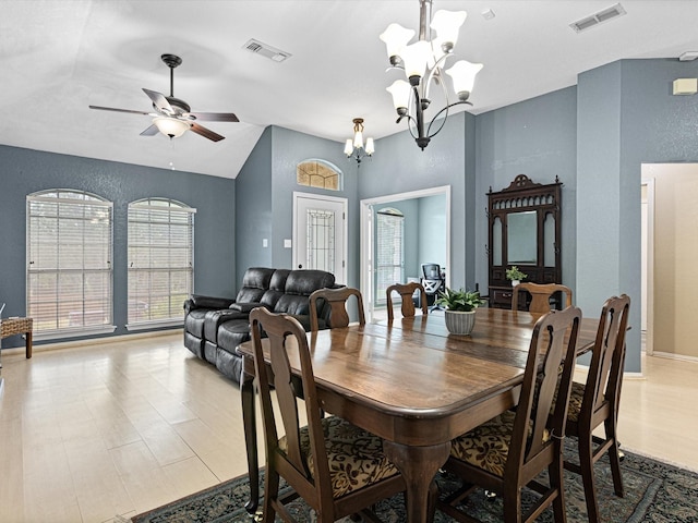 dining area with vaulted ceiling, visible vents, and plenty of natural light