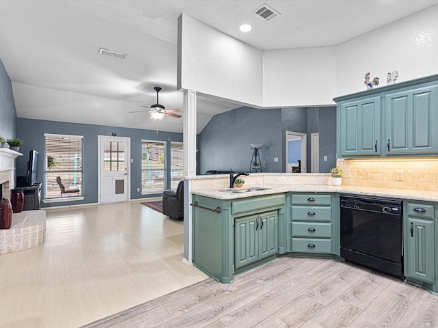 kitchen featuring sink, dishwasher, green cabinetry, vaulted ceiling, and light hardwood / wood-style flooring