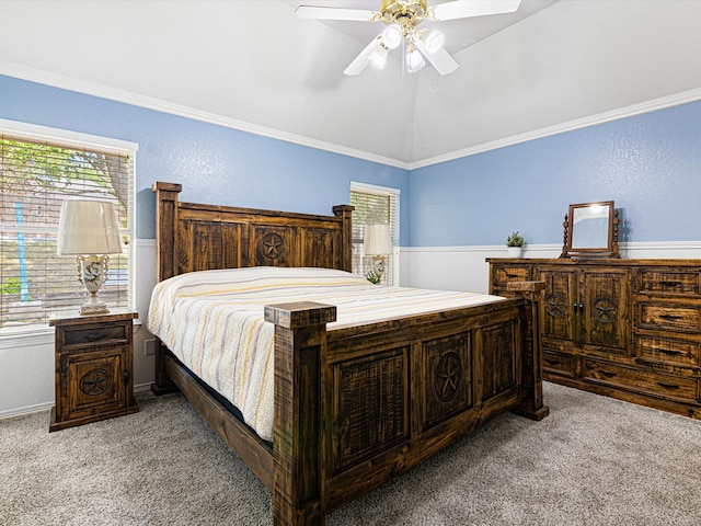 bedroom featuring ceiling fan, ornamental molding, and light colored carpet