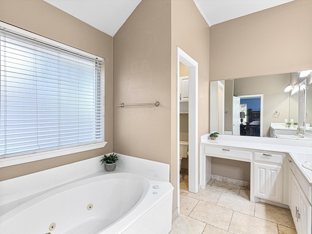 bathroom with vanity, toilet, and a bathtub