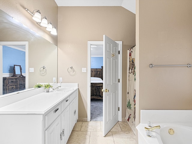 bathroom featuring vanity, lofted ceiling, a bath, and tile patterned flooring