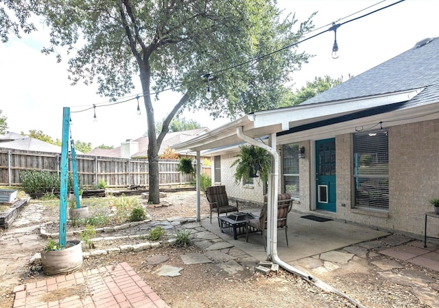 view of patio / terrace featuring an outdoor fire pit and fence