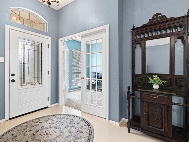 foyer featuring a chandelier