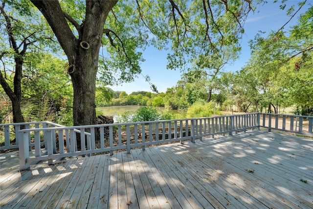 wooden terrace featuring a water view