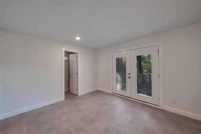 spare room with recessed lighting, french doors, and baseboards