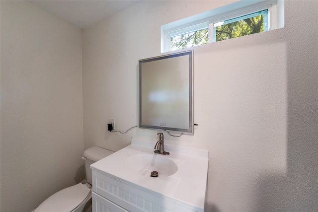 bathroom featuring toilet and vanity