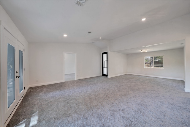 spare room with lofted ceiling and carpet floors