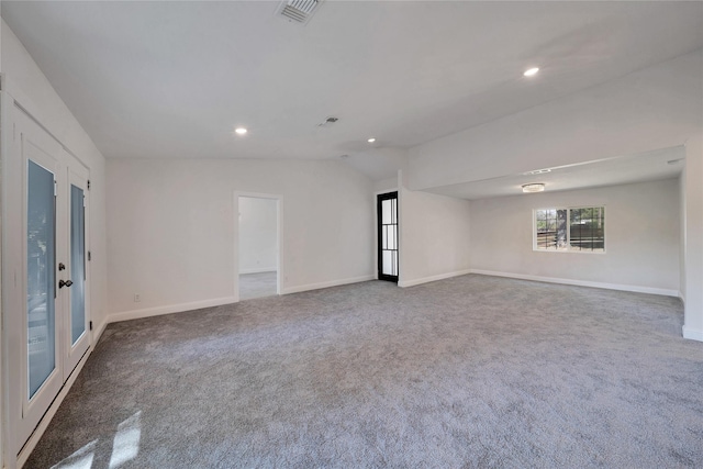 empty room with french doors, carpet, visible vents, and baseboards