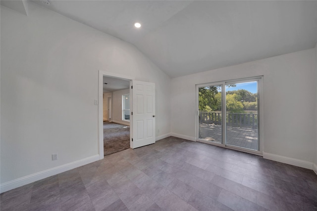 tiled spare room featuring high vaulted ceiling