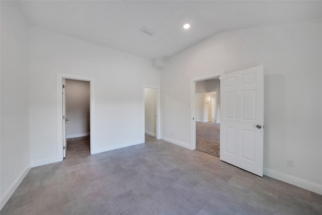 unfurnished bedroom with vaulted ceiling and light carpet