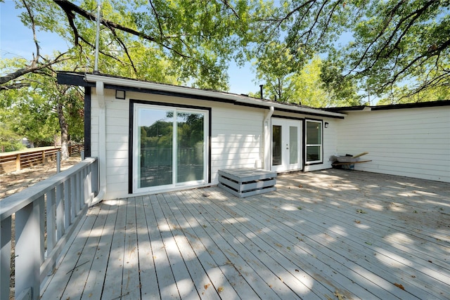 wooden terrace featuring french doors and fence