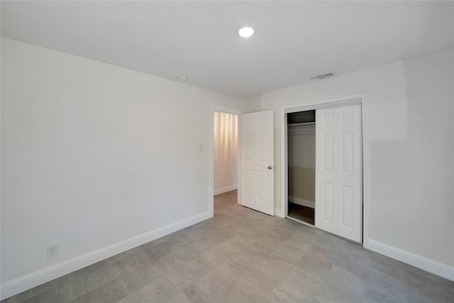 unfurnished bedroom featuring a closet and light tile patterned flooring