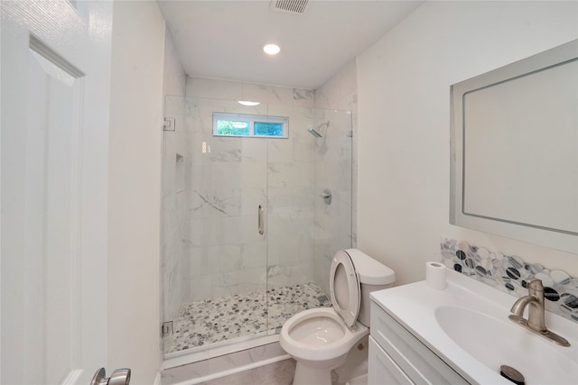 bathroom featuring vanity, toilet, and an enclosed shower