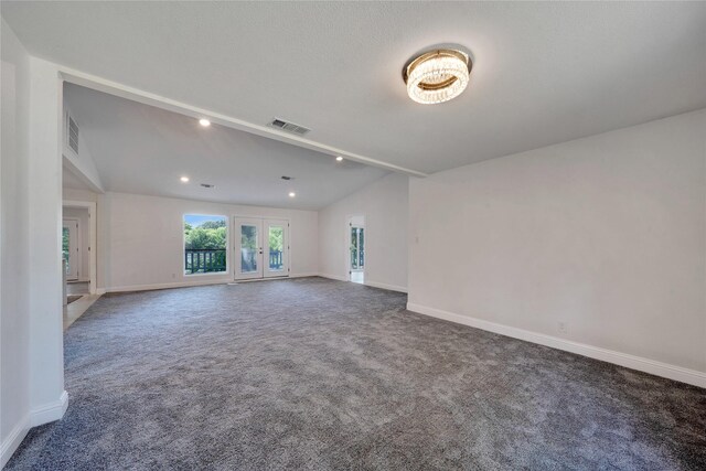 unfurnished room with vaulted ceiling and carpet floors