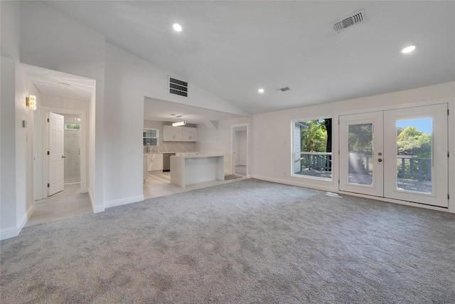 unfurnished living room with recessed lighting, visible vents, french doors, and light colored carpet