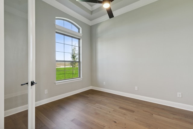 spare room with crown molding, ceiling fan, and wood-type flooring