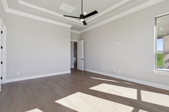 spare room with ceiling fan, a raised ceiling, ornamental molding, and dark wood-type flooring